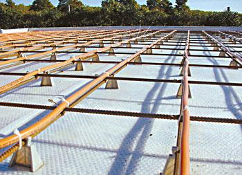 
Orange PEX-AL-PEX pipes will be covered in concrete to form the radiant floor heating system.
